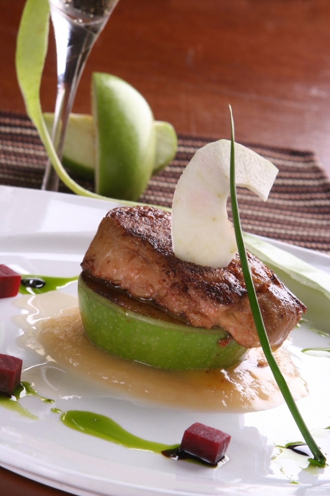 Seared foie gras on green apple with balsamic and chive oil